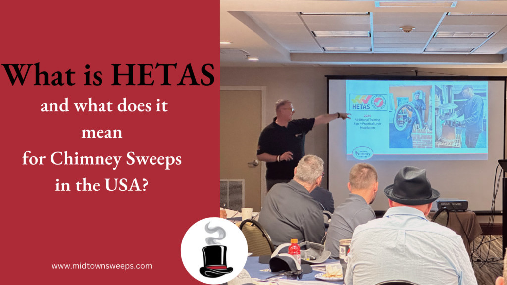 A presenter points to a projected slide about HETAS during a chimney sweeps meeting, with several seated attendees in the foreground and a red informational panel on the left.