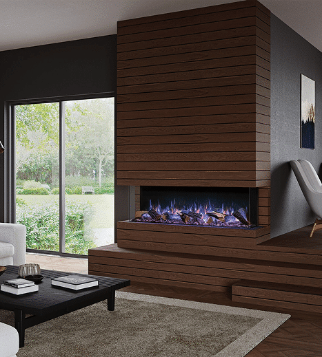 A modern living room features a wood-paneled fireplace with a glass firebox, beside a large floor-to-ceiling window and a low black coffee table on a beige rug.