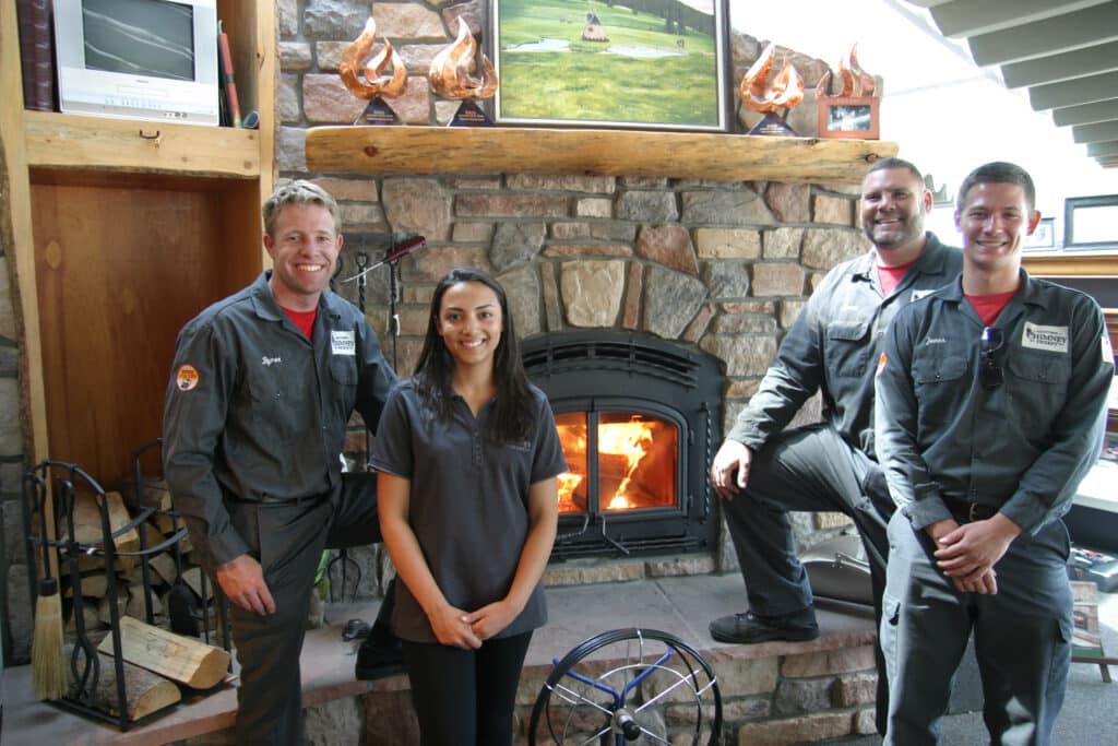 Midtown technician inspecting a gas fireplace log lighter