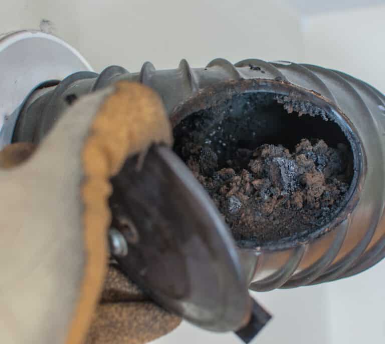 Midtown technician cleaning inside a fireplace